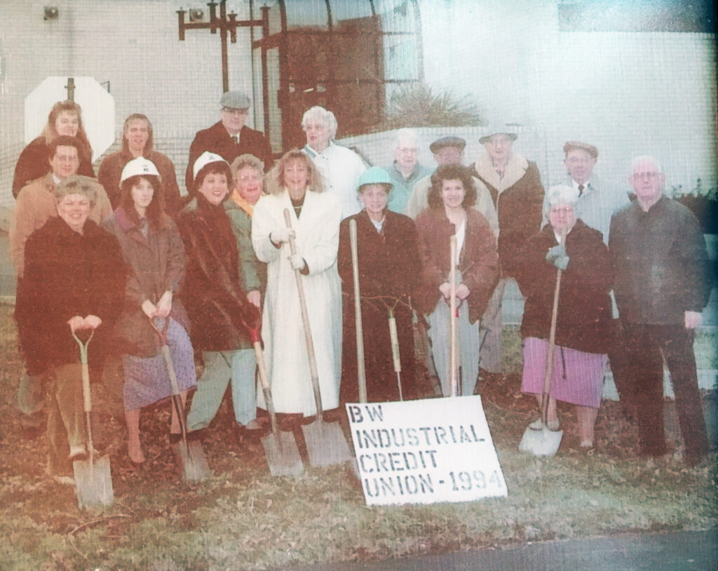 Community photo in front of building, with sign - bw industrial credit union 1994
