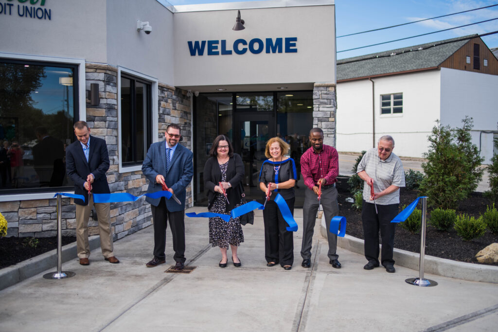 Commstar employees cutting opening ribbon